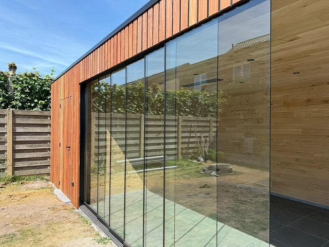Bijgebouw met glazen schuiframen te Ravels